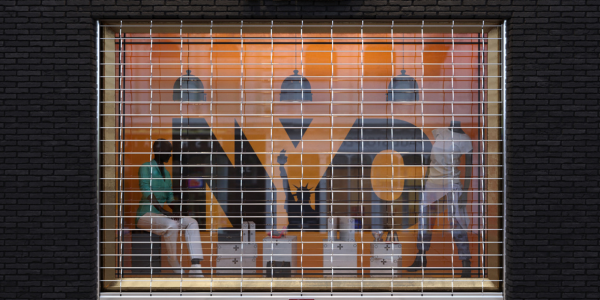 Storefront security grille covering window